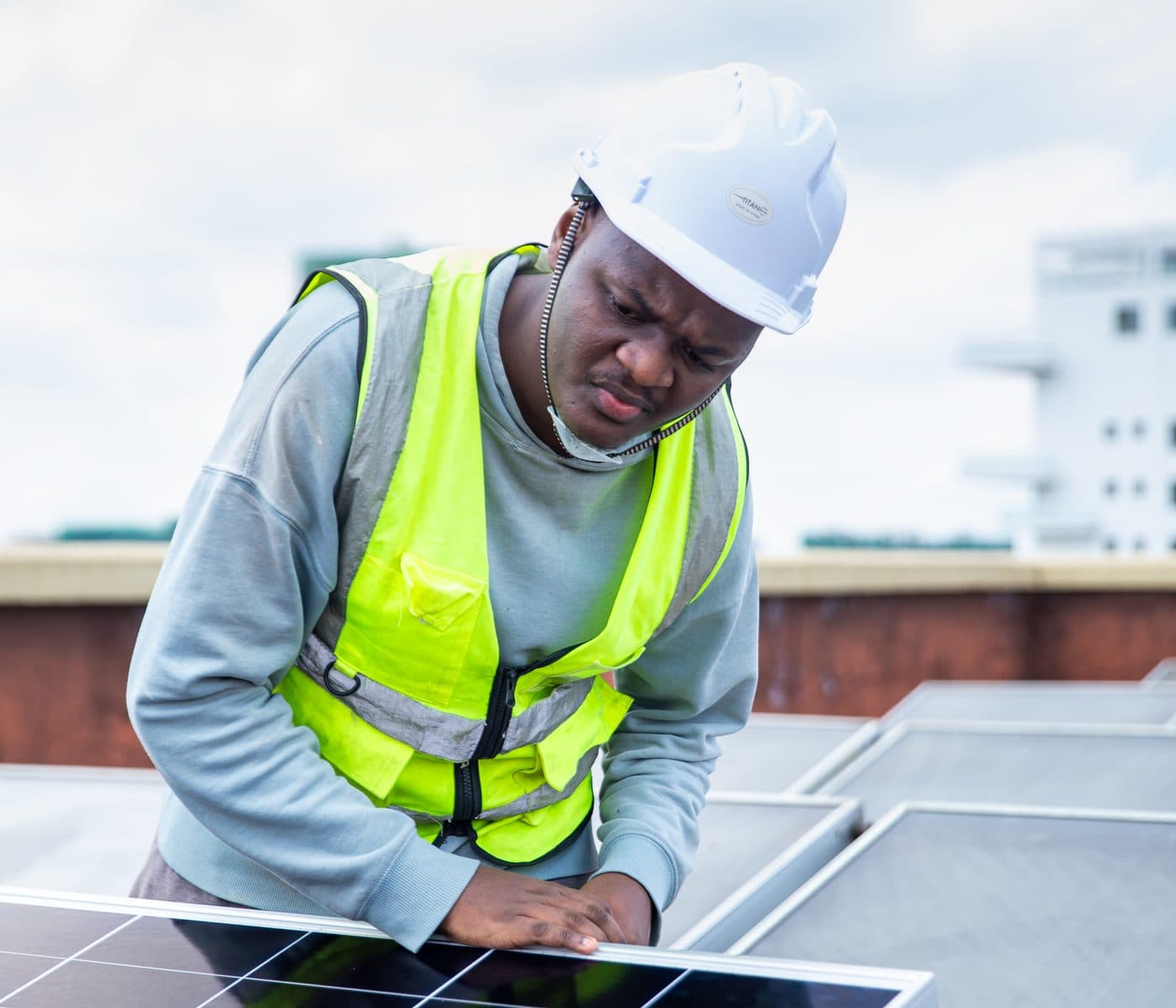 Tesni Energies technician servicing a rooftop solar panel in Kenya